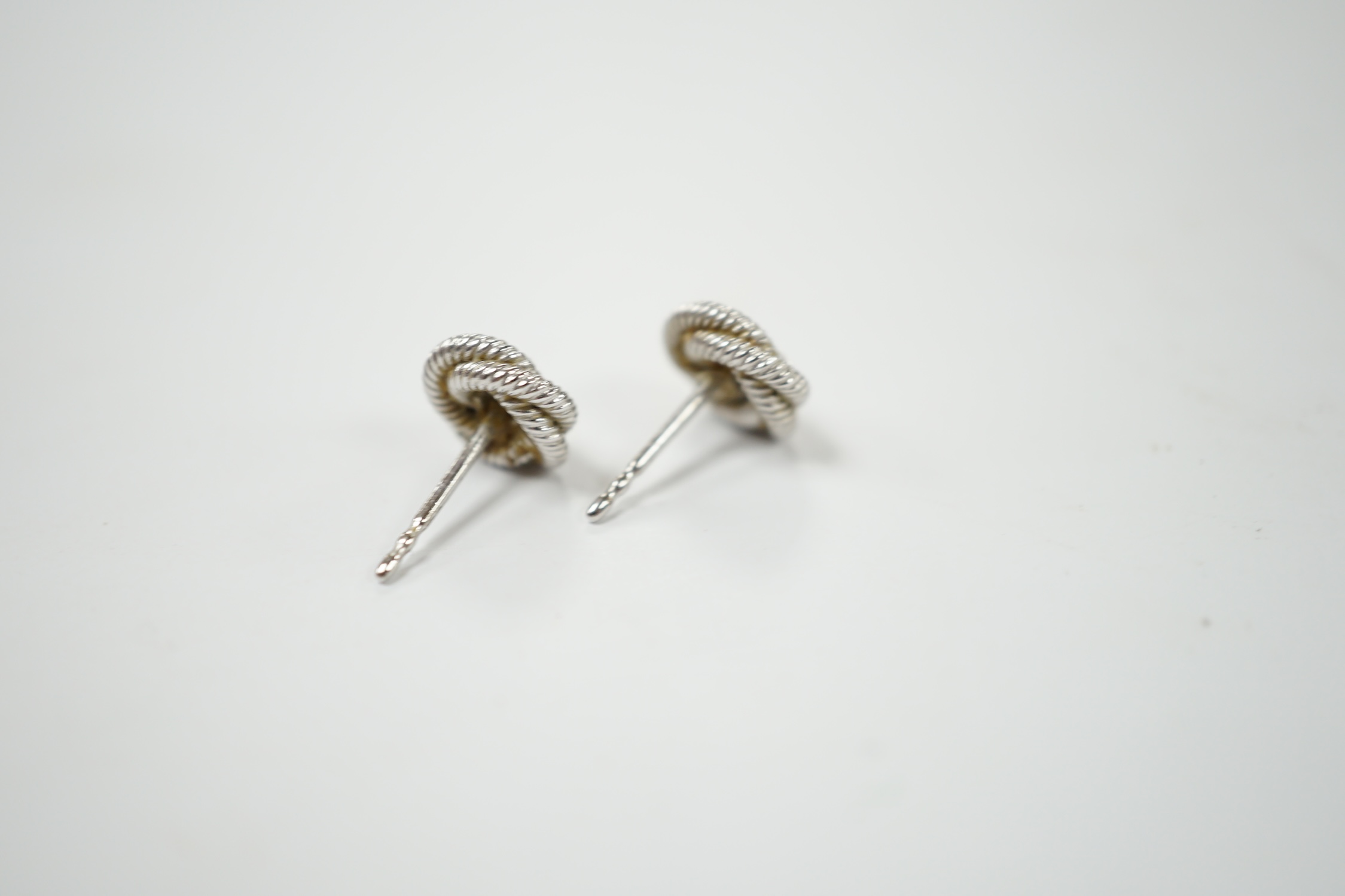 A pair of 750 and diamond chip set 'knot' ear studs with Boodles & Dunthorne butterflies, gross weight 5.2 grams. Condition - fair